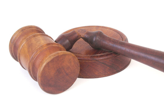 Broken judge gavel isolated on white background. Lawlessness and injustice concept.