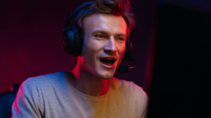 Young male gamer singing into microphone, streaming headset, excited face, neon light, online gaming joy