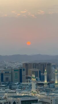 A cinematic sunset view over the mountains and cityscape of Makkah, Saudi Arabia. Ideal for Hajj/Umrah travel promos, Islamic holiday greetings (Ramadan/Eid), and spiritual storytelling. 