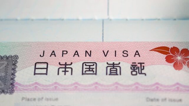 Japan visa sticker in a passport close up view on the page.