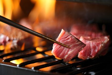 Grilled Steak on BBQ with Tongs - Close Up