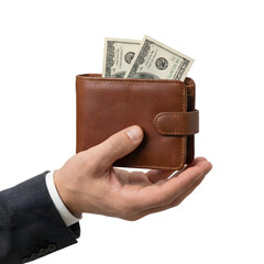 A man's hand in a suit holding an open brown leather wallet with US dollar bills sticking out, isolated on white background.