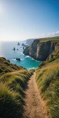 Coastal path descends to turquoise cove cliffs  stacks in sunlight