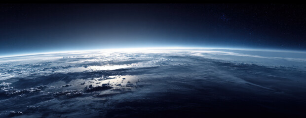 Cinematic view of planet earth from outer space at sunrise with bright blue atmospheric glow over clouds and ocean under a vast starry dark sky horizon showing the beauty of global connectivity