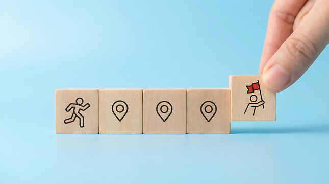 Steps to success and goal achievement concept with wooden blocks showing a journey from start to reaching the finish line with a red flag