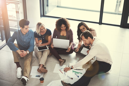 Business, people and meeting with paperwork in office for campaign oversight, KPI stats or planning. Digital marketing, team and SEO graphs on floor for competitor analysis, brand strategy and above