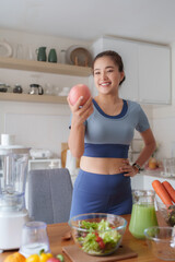 Young woman enjoying healthy apple preparing fresh meal