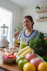 Woman preparing fresh healthy salad in kitchen