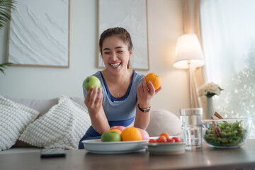 Healthy asian woman choosing fruits for balanced diet