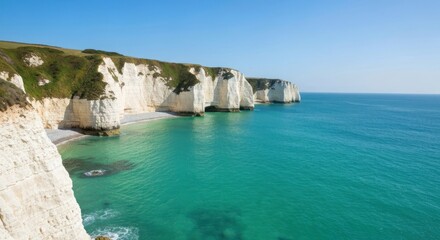 Fototapeta premium Majestic white chalk cliffs tower over turquoise waters on a bright sunny day