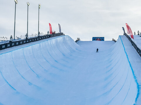 Calgary, Alberta, Canada. January 22, 2026. Snowboarder at Winsport COP halfpipe during winter. Snowboarder prepares for run on snow-covered halfpipe at Winsport COP in Calgary during winter