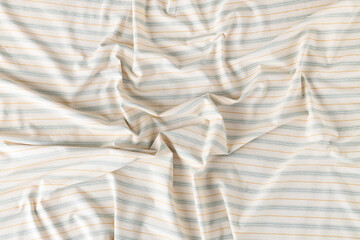 Crumpled white striped tablecloth as background, top view