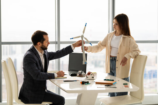 Teenage student discussing renewable energy project with mentor