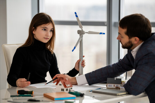 Teenage student discussing renewable energy project with mentor
