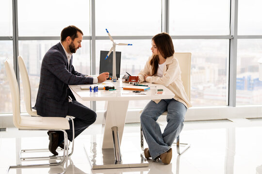 Teenage student discussing renewable energy project with mentor