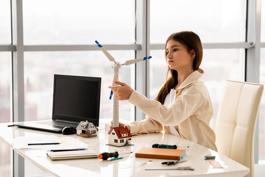 Teenage student assembling wind turbine model, STEM learning