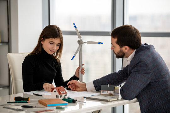 Teenage student discussing renewable energy project with mentor