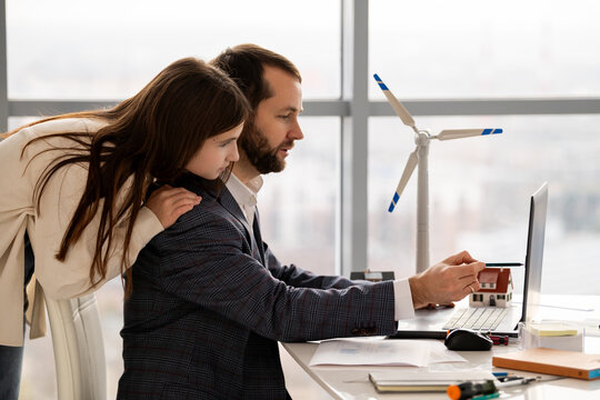 Teenage student discussing renewable energy project with mentor