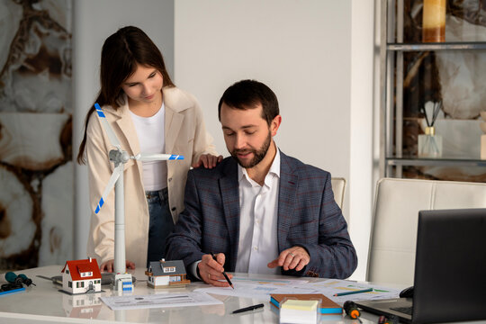 Teenage student discussing renewable energy project with mentor