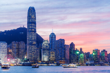 Hong Kong city skyline at sunset with glowing sky and skyscrapers