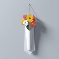 White wall-mounted vase holds colorful paper flowers on a gray wall