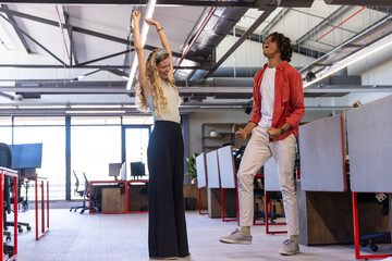 Natural light streaming through windows illuminating computer monitors and ergonomic chairs