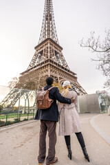 Couple embracing while visiting eiffel tower in paris