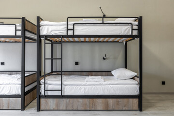 Modern industrial style bunk beds in hostel dormitory room