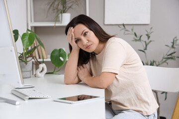 Worried woman sitting at table