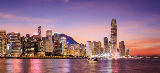 Hong Kong city skyline at sunset with glowing sky and skyscrapers © Evgeny Karandaev