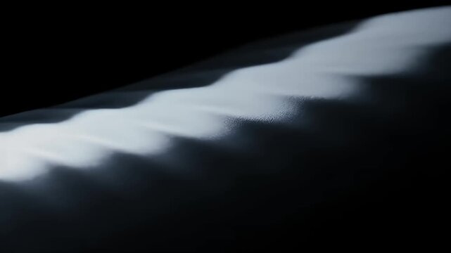 Close-up of a traditional Japanese katana blade showing the intricate hamon temper line against a dark, dramatic background.