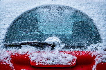 Frost forms on a car windshield during a cold morning in winter