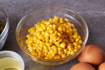 Boiled canned corn in a bowl on the table.
