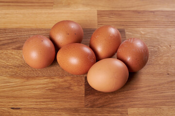 Six chicken eggs on the table.