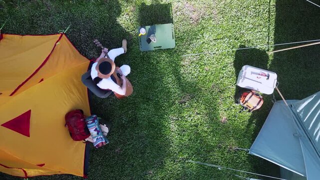 Asian women camping alone with mountain view. Solo outdoor activity and journey lifestyle on holiday.