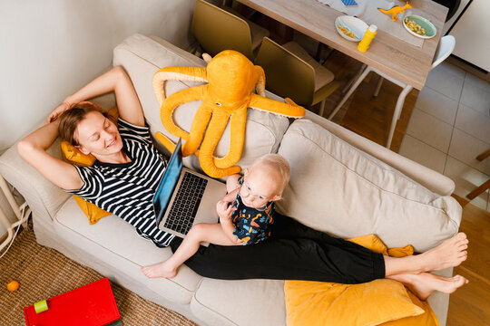 Mother and son relaxing together on the couch at home