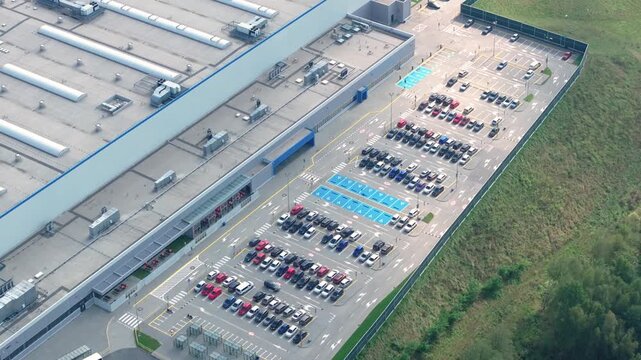 Aerial view of a factory parking lot and facility layout in a manufacturing area