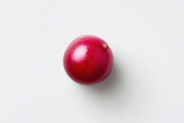 Obraz premium Overhead shot of a ripe red fruit with soft shadow on white backdrop
