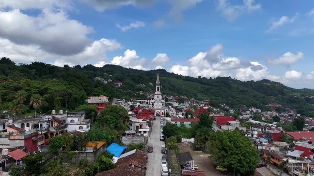 Main Street of picturesque latin village of Cuetzalan. Aerial dolly in