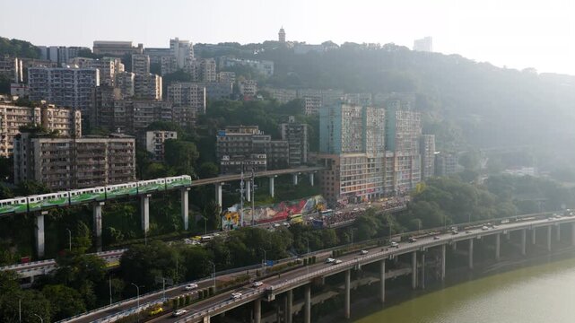 Monorail Train Coming Through A Residential Building At Liziba Station In Chongqing, China. - aerial shot
