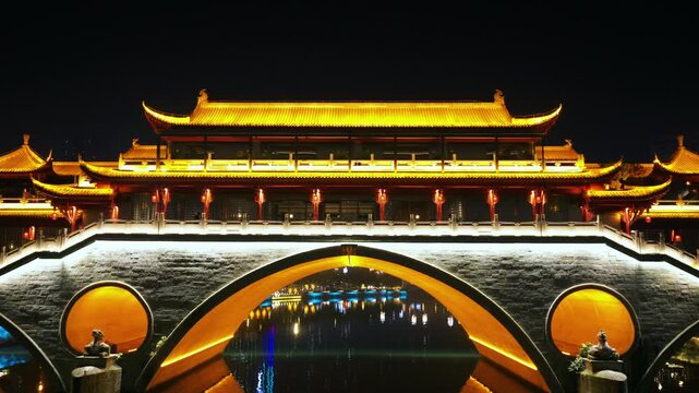 Anshun Bridge With An Upscale Restaurant Illuminated At Night In Chengdu, Sichuan, China. - aerial pullback shot
