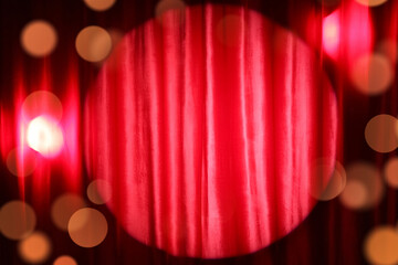 Shining spotlight on red curtain