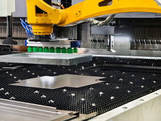 Advanced robotic arm working on metal sheet in modern manufacturing facility for precise cutting and shaping tasks