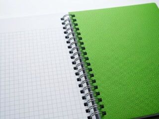 Green spiral notebook with grid paper
