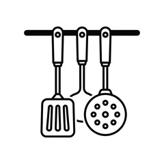 Kitchen utensils hanging on a rail