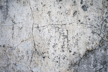 Obraz premium Cracked rough concrete wall with weathered surface