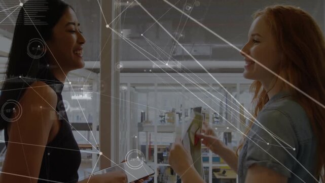 Network connections and data points animation over two women shaking hands in office