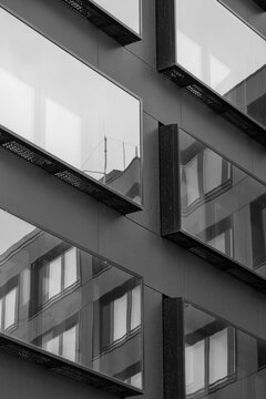 Modern monochrome architecture facade building with windows and sharp angles creating contrast and abstract pattern for minimalist urban exterior texture