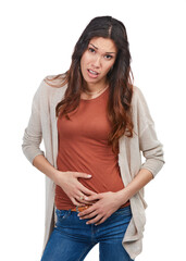 Fototapeta premium Portrait, woman and unhappy in studio with stomach ache from indigestion, unhealthy gut or diet. Uncomfortable, person and abdominal pain from IBS, bloating issue or constipation on white background.