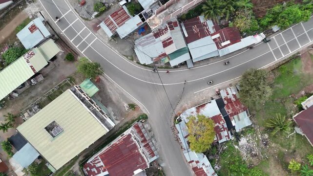 Cinematic Aerial Drone Hovering Above Three-Way Road Intersection in Rural Village